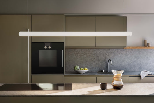 Occhio Mito volo pendant luminaire above a modern kitchen island
